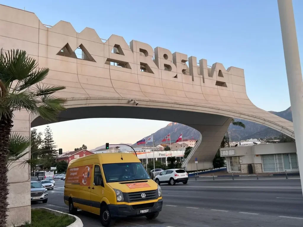 Camion de déménagement passant sous l'arche de Marbella - International Moving Transports Suisse-Espagne